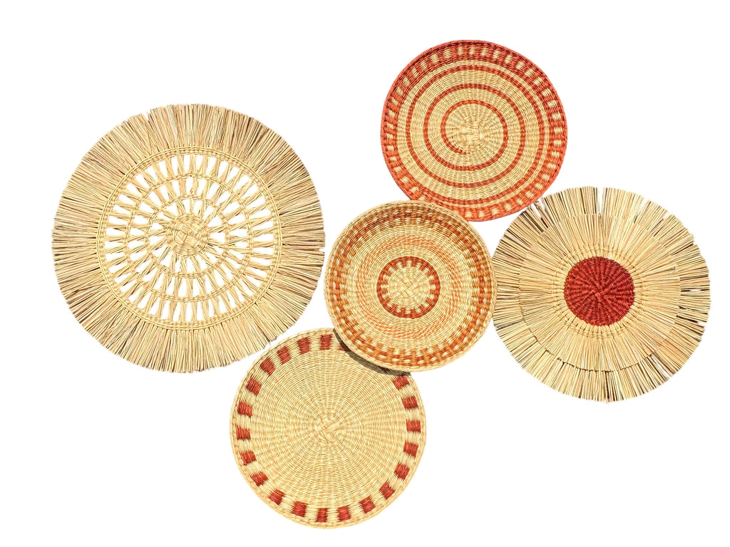 Set of five woven plates with red and beige patterns on a white background